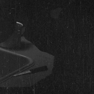 Turntable in a dark room, lit by a light.