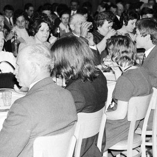 Group of people dining at a formal event.