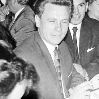 Group of people seated at a table during an event.