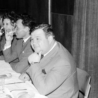 Group at a formal dinner, toasting with champagne.