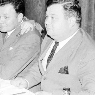 Group seated at a table, possibly during a gathering.