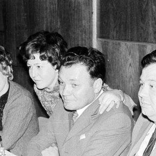 Group seated at a table, possibly during a gathering.