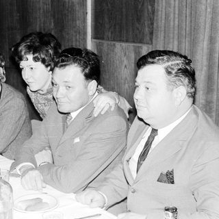 Group seated at a table, possibly during a gathering.