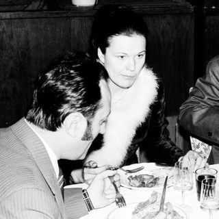 People dining at a restaurant, appearing to be in conversation.