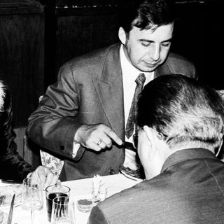 People dining at a restaurant, appearing to be in conversation.