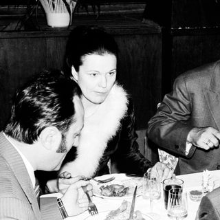 People dining at a restaurant, appearing to be in conversation.