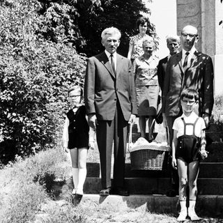 Black and white photo of a family on stone steps.