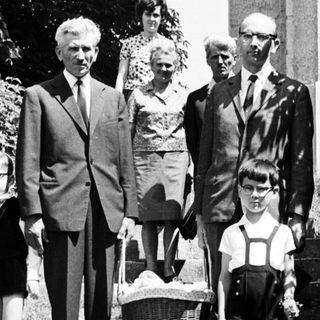 Black and white photo of a family on stone steps.