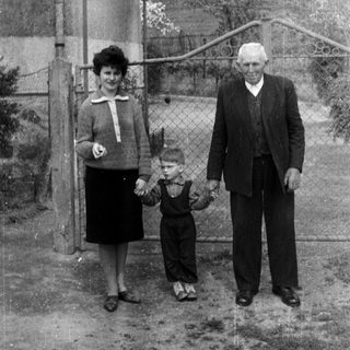 Black and white photo of a family standing outside.