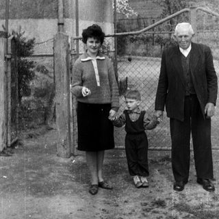 Black and white photo of a family standing outside.