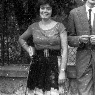 Black and white photo of three people standing outdoors.