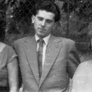 Black and white photo of three people posing outdoors.