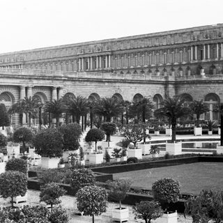 Grand palace with formal gardens and manicured landscaping.
