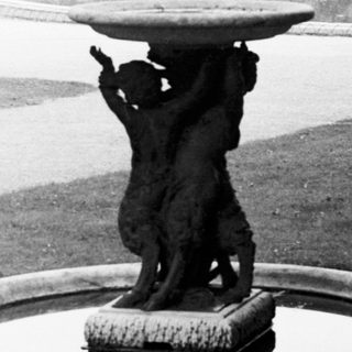 Black and white photo of a formal garden with statues.