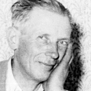 Man with injured leg, seated in a room.