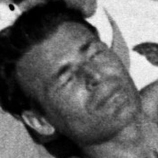 Injured man lies in snow, woman kneels nearby.