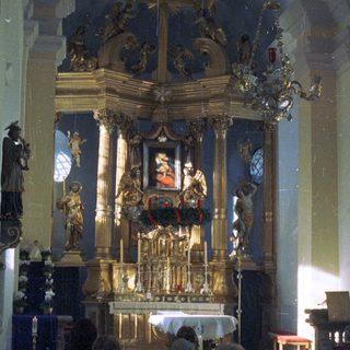 Elaborate altar with religious statues in an ornate church.
