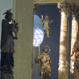 Elaborate altar with religious statues in an ornate church.