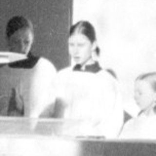 Here's a brief summary of the image: Religious ceremony taking place in a church setting.