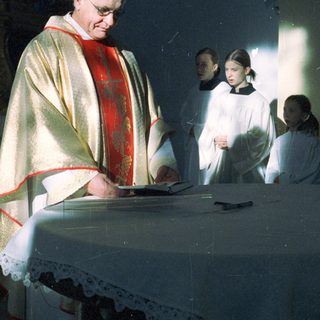 Priest and altar servers during a religious ceremony.