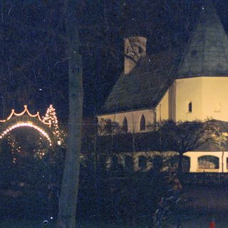 Night view of a building with a lit archway.