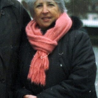 An older couple stands outside, bundled up against the cold.