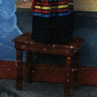 Girl in traditional dress poses for a photograph.