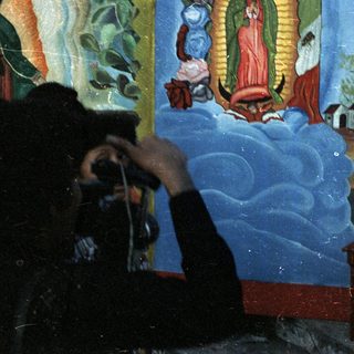 Girl in traditional dress poses for a photograph.
