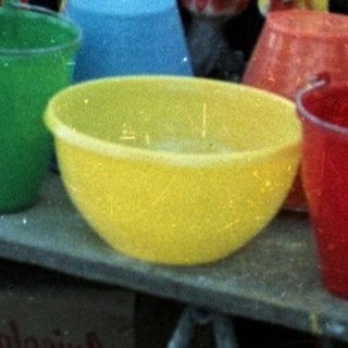 Man arranges ceramic roosters for a game display.