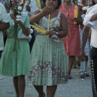 Parade or procession with musicians and onlookers.