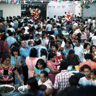 Crowded gathering of people, likely a community celebration.