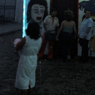 Sign for "El Palacio de la Ilusion" with performers depicted.