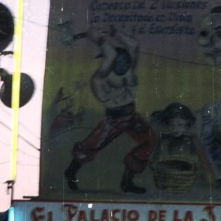 Sign for "El Palacio de la Ilusion" with performers depicted.