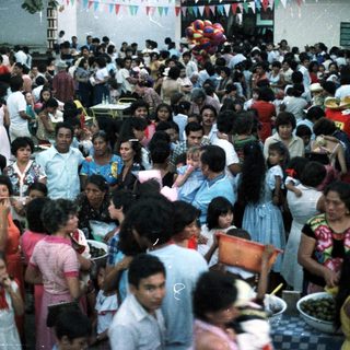Large crowd of people gathered outdoors, likely a celebration.