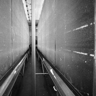 Long hallway with railings and a visible ceiling.