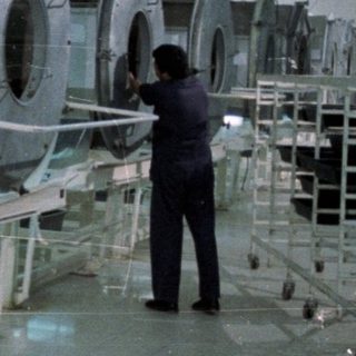 Film reels on racks in a processing facility.