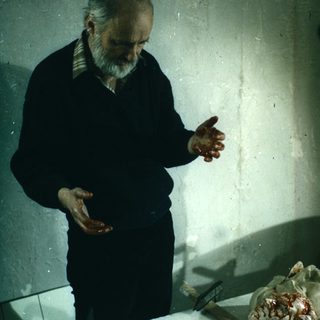 Man demonstrating anatomical model, likely a brain or organ.
