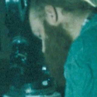 Film crew member adjusting a prop during a scene.