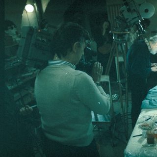 Here's a brief summary of the image: Scientists examining a specimen in a laboratory setting.