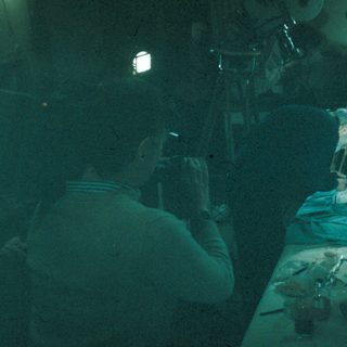 Man performing a dissection on a body.