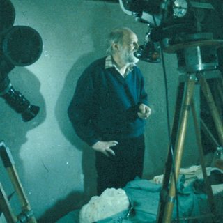 Film crew working on a movie set with a camera.