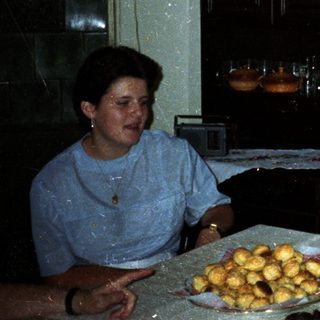 Family seated at a table with food and drink.