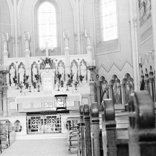Interior of a church with altar and statues.
