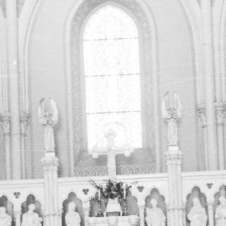Interior of a church with altar and statues.