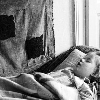 Child sleeping peacefully on a couch.