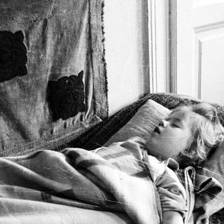 Child sleeping peacefully on a couch.