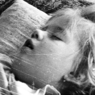 Child sleeping peacefully on a couch.