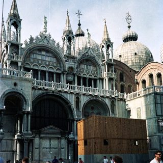 St. Mark's Basilica in Venice, with people and pigeons.