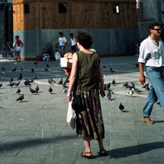 St. Mark's Basilica in Venice, with people and pigeons.