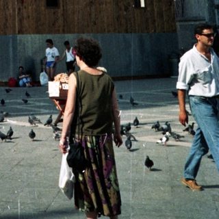 St. Mark's Basilica in Venice, with people and pigeons.